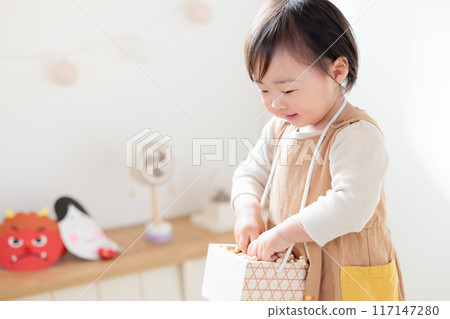 Infant (1 year old) enjoying bean-throwing Infant (1 year old) enjoying bean-throwing 117147280