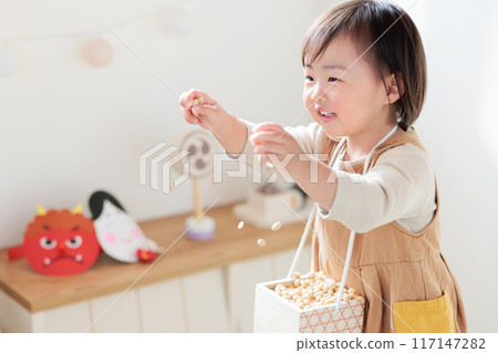 Infant (1 year old) enjoying bean-throwing 117147282