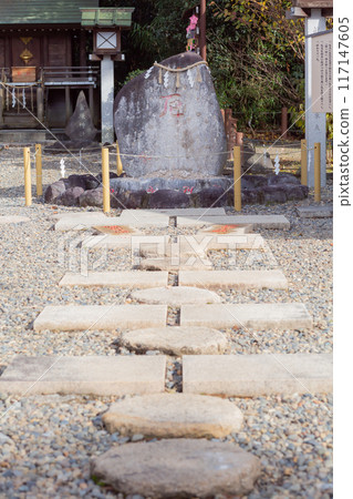 [Japan] Stone pavement leading to a sacred rock draped with a rope at Sakuragi Shrine in Noda City, Chiba Prefecture 117147605