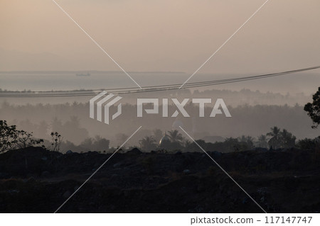 Misty morning atmosphere in Pekosong village, Lombok, Indonesia 117147747