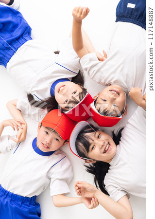Children lying down in gym clothes Children lying down in gym clothes 117148887