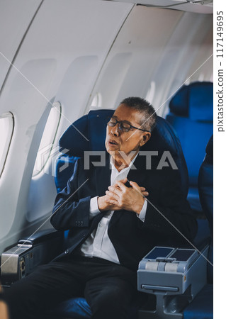 headache in the airplane, man passenger afraid and feeling bad during the flight in plane 117149695