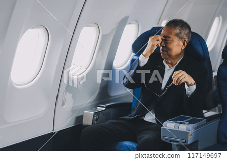 headache in the airplane, man passenger afraid and feeling bad during the flight in plane 117149697