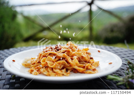 Tagliatelli with bolognaise meat sauce with parmesan 117150494