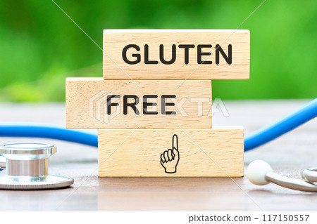 top view Phrase Gluten free written on wooden blocks against a background of blurred green plants top view Phrase Gluten free written on wooden blocks against a background of blurred green plants 117150557