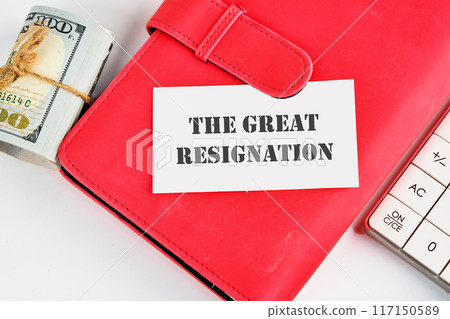 Text THE GREAT RESIGNATION, mass voluntary exodus from the workforce. THE GREAT RESIGNATION on a business card on a red notebook with dollars and a calculator lying next to it Text THE GREAT RESIGNATION, mass voluntary exodus from the workforce. THE GREAT RESIGNATION on a business card on a red notebook with dollars and a calculator lying next to it 117150589