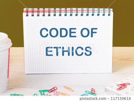 Business and code of ethics concept. Copy space. Concept words Code of ethics in a checkered notebook on the table Business and code of ethics concept. Copy space. Concept words Code of ethics in a checkered notebook on the table 117150618