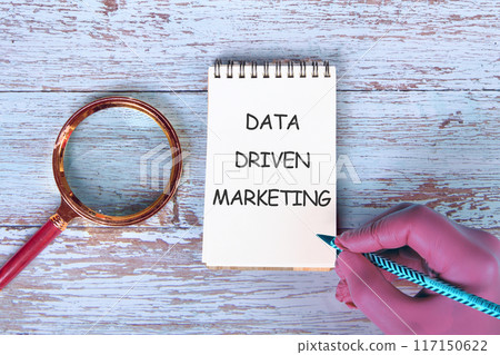 Internet concept. Business concept. Business idea. DATA DRIVEN MARKETING text in a notebook on the background of antique boards 117150622