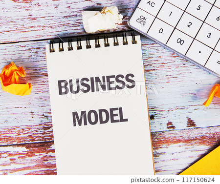 Copy space. Conceptual business model symbol. Business model message written in a white notebook on old boards Copy space. Conceptual business model symbol. Business model message written in a white notebook on old boards 117150624