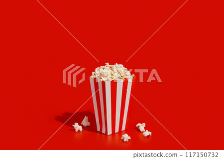 Striped box with popcorn on a red background 117150732
