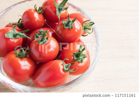Cherry tomatoes in a glass container 117151161