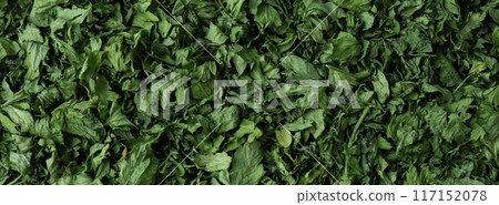 Dry parsley spice background. Homegrown herbs and spices for cooking backdrop. Fresh dried aromatic natural food ingredients 117152078