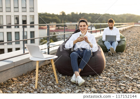 Remote work and relaxation on rooftop with bean bags 117152144