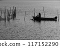 Fisherman raising net 117152290