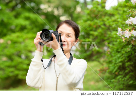 Senior woman holding a camera 117152527
