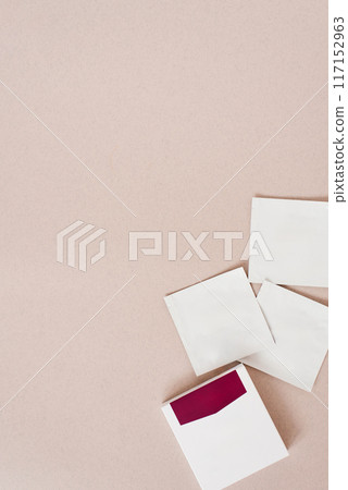 Disposable bags of cosmetics lie on a beige background 117152963