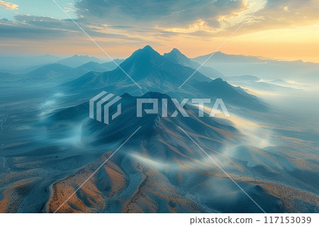 Mountain range with a foggy mist in the air Mountain range with a foggy mist in the air 117153039