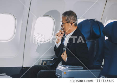 headache in the airplane, man passenger afraid and feeling bad during the flight in plane 117153389
