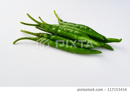 Green chili peppers on white background (with copy space) 117153416