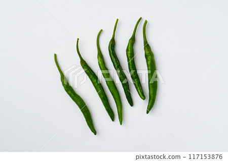 Green chili peppers on white background (with copy space) 117153876