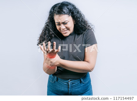 Young woman with arthritis isolated.. Wrist pain and arthritis concept. People with wrist pain and arthritis isolated 117154497