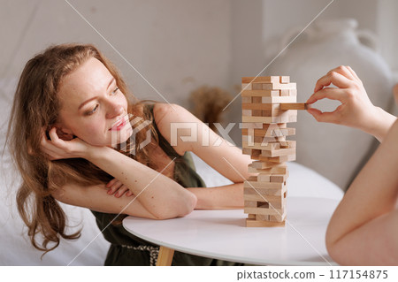 two women playing a board game made of wooden blocks at home, excitement and relaxation, mind development concept, hand motor skills, two women playing a board game made of wooden blocks at home, excitement and relaxation, mind development concept, hand motor skills, 117154875