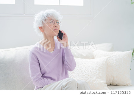 Elderly woman talking on smartphone Elderly woman talking on smartphone 117155335