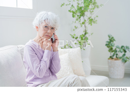 Elderly woman talking on smartphone Elderly woman talking on smartphone 117155343