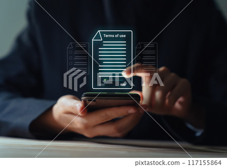 Businessman using smartphone and reading terms of service by signing to accept terms and conditions. 117155864