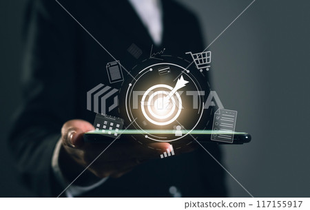 Businessman holding smartphone with show target goal on virtual screen, future growth, planning and success business concept. Businessman holding smartphone with show target goal on virtual screen, future growth, planning and success business concept. 117155917