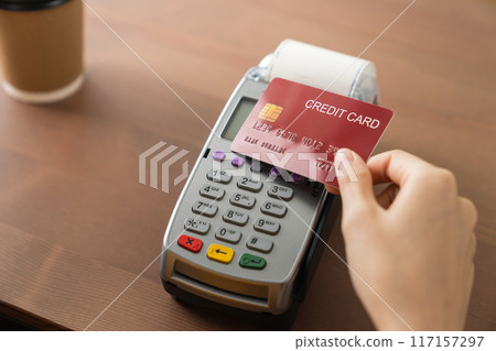 Customers using credit card touch on card swipe machine for to pay, NFC technology. Customers using credit card touch on card swipe machine for to pay, NFC technology. 117157297