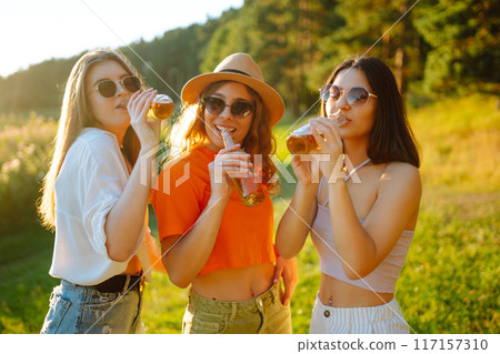 Happy groop of friend resting in nature in picnic drinking beer, cheers. People lifestyle relaxation 117157310