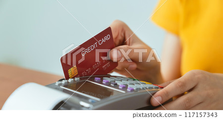 Customers using credit card on card swipe machine for to pay. Customers using credit card on card swipe machine for to pay. 117157343