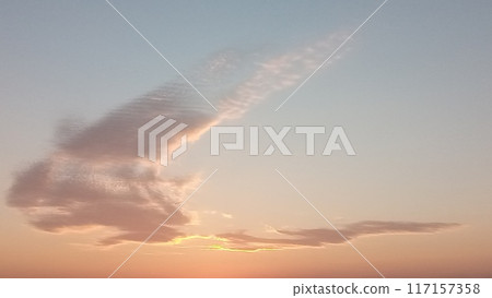 Graceful cirrus cloud drifting in the sky during a breathtaking sunset 117157358