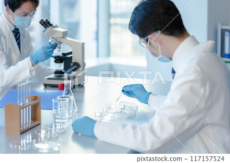 Businessman conducting an experiment 117157524
