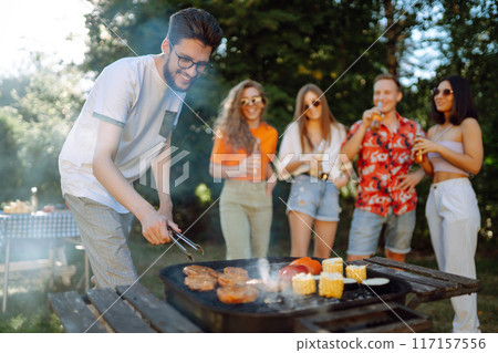 ?ompany of people having bbq party on in summer park. Lifestyle, holidays, weekend, leisure concept. 117157556