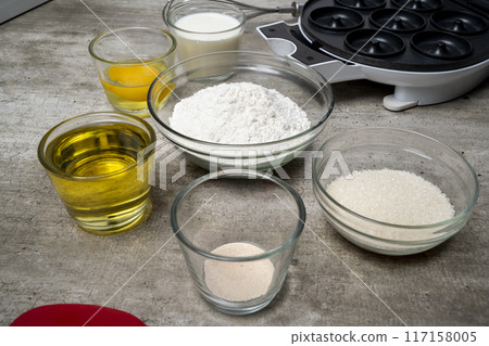 A table with several bowls of ingredients, including flour, sugar, and oil A table with several bowls of ingredients, including flour, sugar, and oil 117158005