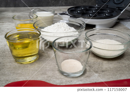 A table with several bowls of ingredients, including flour, sugar, and oil A table with several bowls of ingredients, including flour, sugar, and oil 117158007