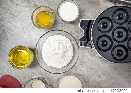 A table with several bowls of ingredients, including flour, sugar, and oil A table with several bowls of ingredients, including flour, sugar, and oil 117158011