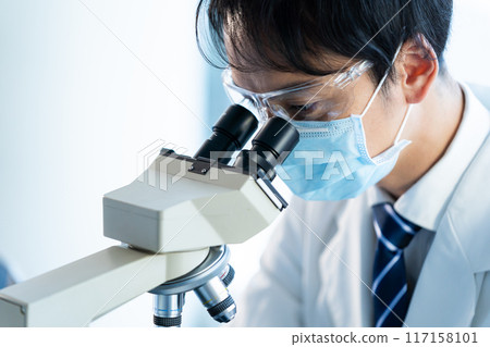 Businessman conducting an experiment 117158101