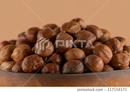 Hazelnuts in a wooden bowl close-up 117158171