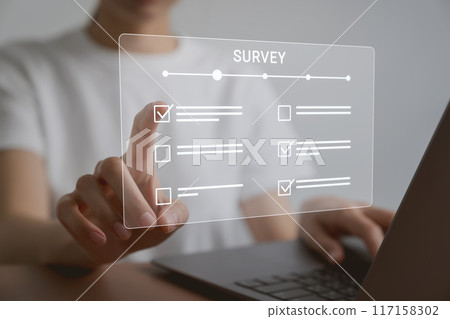 Hand using laptop and filling survey form online. Hand using laptop and filling survey form online. 117158302