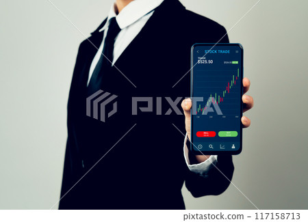 Businessman trader using smartphone with stock market investments and graph on screen to analyze trading data, buy or sell and checking price on mobile application. 117158713