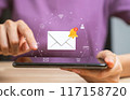 Woman hand using smartphone and shows a digital screen of new email notifications, messages to delivery. 117158720