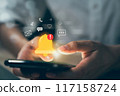 Hand using smartphone with showing the bell icon and notifications of new messages on application. 117158724
