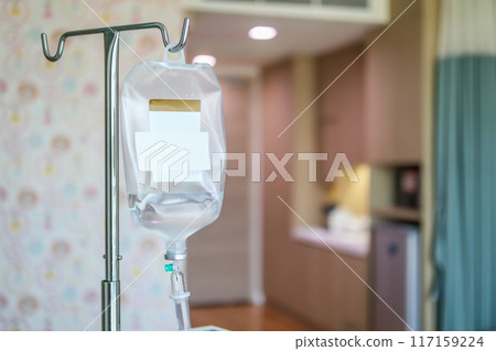 Close up medical intravenous IV drip in hospital background 117159224