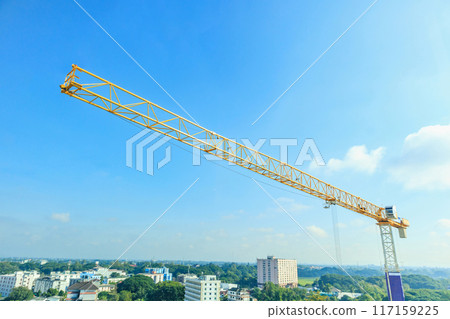 Industrial construction crane with blue sky background at building site Industrial construction crane with blue sky background at building site 117159225