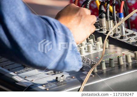 Technician using sound audio mixing system Technician using sound audio mixing system 117159247
