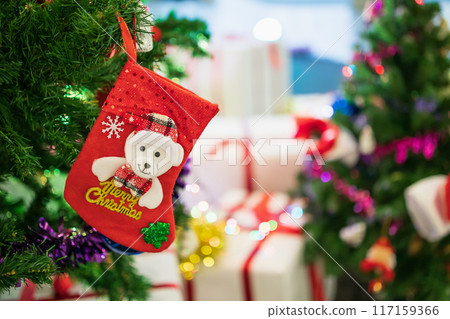 Decorated Christmas socks baubles on fir tree New Year holidays background 117159366
