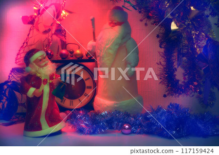 Happe New Year.Santa Claus and vintage clock in red Christmas lights Happe New Year.Santa Claus and vintage clock in red Christmas lights 117159424